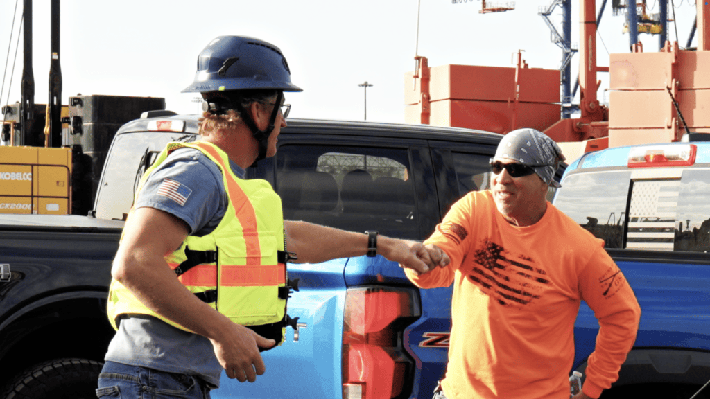 Trevcon marine construction crew member performing heavy waterfront rigging on location during industrial safety video training series production by Faithful Dog Digital